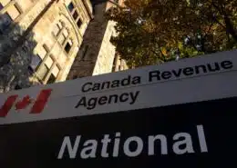 Signage showing Canada Revenue Agency (CRA) next to a building - CRA Mandatory Disclosure Rules Guidance - KR Law Firm - Tax Law Firm in Toronto